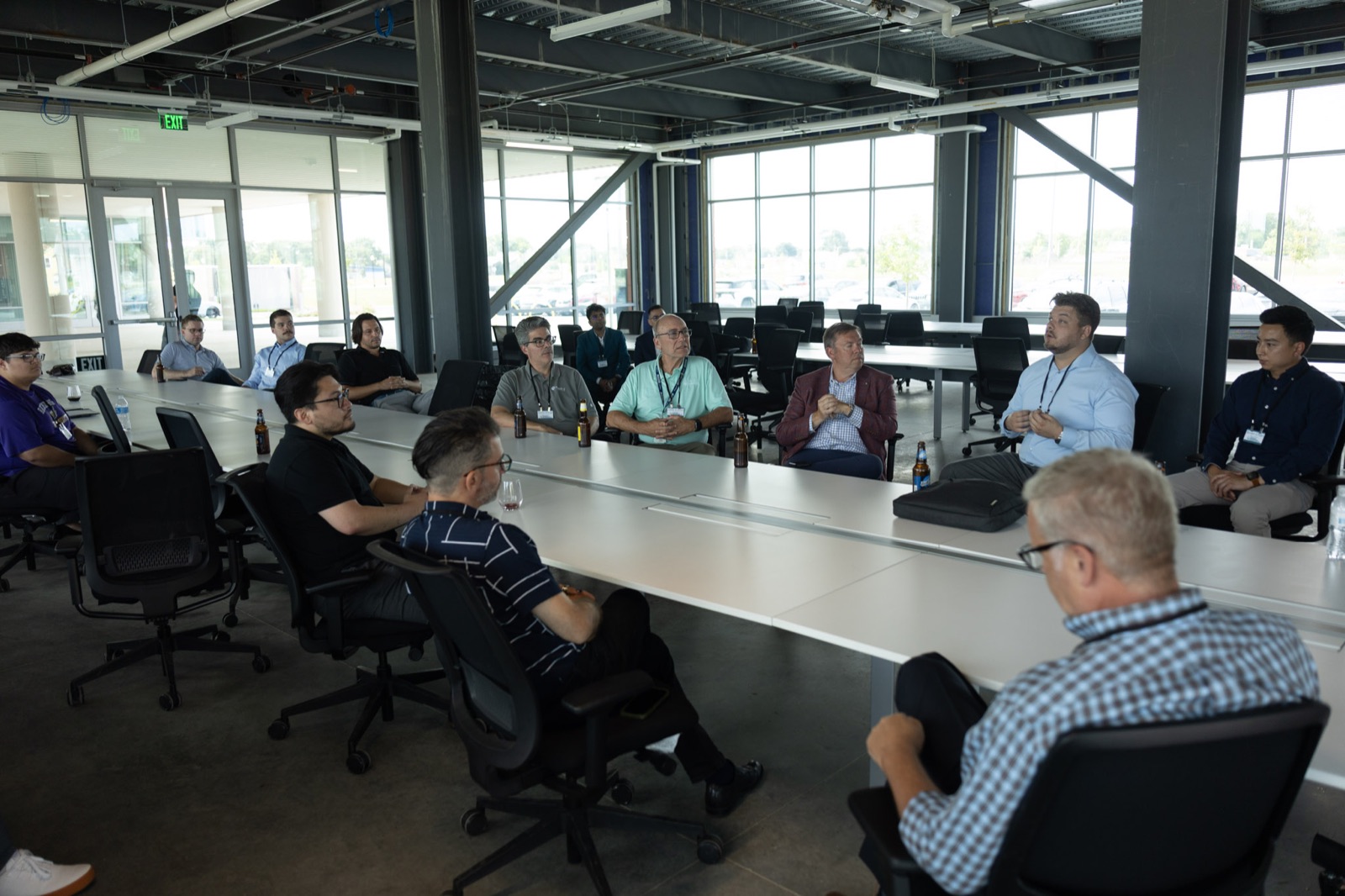 Great Lakes Technology Corridor attendees seated around a conference table during a group discussion.